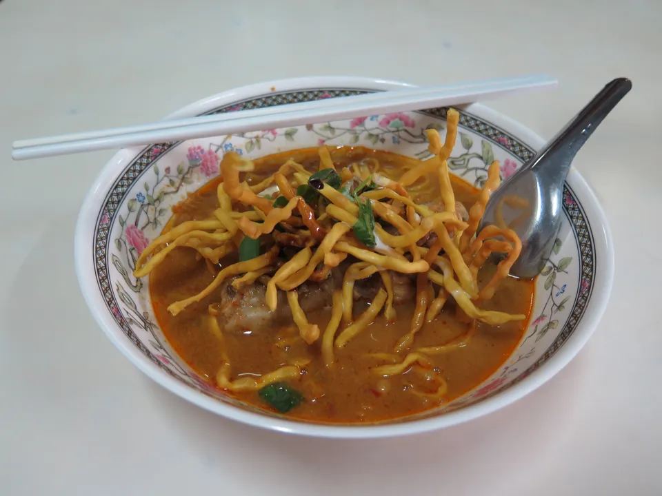 A bowl of khao soi with crisp noodles in Chiang Mai