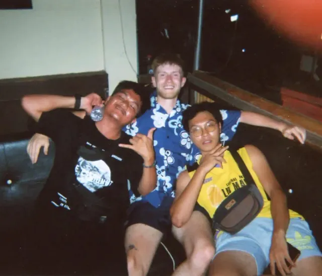 Friends laughing together in an informal indoor photograph