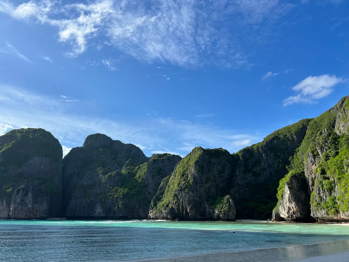 Limestone cliffs, turquoise shallows and a sandy edge at Maya Bay